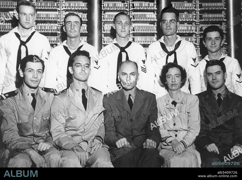 Grace Hopper and Howard Hathaway Aiken (bottom center) with unidentified members of the Bureau of Ordnance Computation Project, sitting in front of the Harvard Mark 1 computer. The IBM Automatic Sequence Controlled Calculator (ASCC), called Mark I by Harvard University’s staff, was a general purpose electromechanical computer that was used in the war effort during the last part of WWII. One of the first programs to run on the Mark I was initiated on March 29, 1944 by John von Neumann. At that time, von Neumann was working on the Manhattan project, and needed to determine whether implosion was a viable choice to detonate the atomic bomb that would be used a year later. The Mark I also computed and printed mathematical tables. The Mark I had 60 sets of 24 switches for manual data entry and could store 72 numbers, each 23 decimal digits long. It could do 3 additions or subtractions in a second. A multiplication took 6 seconds, a division took 15.3 seconds, and a logarithm or a trigonometric function took over one minute. The first programmers of the Mark I were computing pioneers Richard Milton Bloch, Robert Campbell, and Grace Hopper.