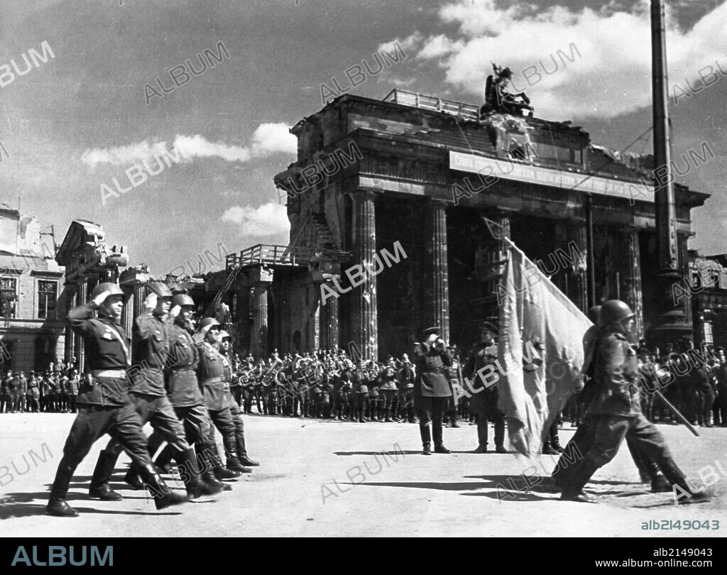 Soviet red army troops during a victory parade in front of the brandenburg gate in berlin, germany at the end of world war 2, may 20, 1945.