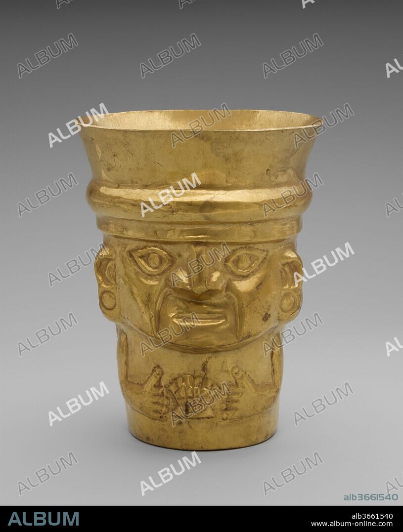 Beaker with Figure Displaying a Shell. Culture: Lambayeque (Sicán). Dimensions: H. 10 3/8 x Diam. 8 in. (26.4 x 20.3 cm). Date: A.D. 900-1100.
These drinking vessels were likely used in ceremonial feasts before they were deposited in a high-status tomb. The beaker shows an individual clasping a Spondylus shell. Production of silver and gold objects in the Lambayeque culture reached epic proportions, and dozens, even hundreds, of vessels were placed in a single burial. Beakers were created in a centralized workshop.

Estas copas de oro eran probablemente utilizadas en festines ceremoniales antes de ser colocadas en tumbas de personajes de alto rango. La producción de objetos de oro y plata en la cultura Lambayeque alcanzó proporciones históricas, con decenas o incluso centenares de vasijas colocadas en una única tumba. Sin duda las copas eran fabricadas en talleres centralizados, en los que los lingotes de dimensiones estándar eran transformados en objetos. Una de las copas presenta un personaje sujetando una concha Spondylus; la otra copa representa a una deidad en posición invertida. La orientación de la cara de la deidad se puede relacionar con prácticas rituales y con el consumo del líquido contenido en la copa.

This gold drinking vessel in the shape of a figure displaying a shell comes from the Lambayeque culture of Peru's north coast and was created for use in ceremonial feasts before it was eventually deposited in the tomb of a high-status individual. This type of vessel shape originated in the south-central Andes, where tall ceramic beakers with flaring rims were popular in the earlier Tiwanaku and Wari cultures. A few examples of beakers made of precious metals and sculpted in the shape of a head are known from these southern cultures, but they do not appear to have been made in large quantities. After the ninth century A.D., however, vessels made of precious metals were made in greater numbers farther north, in the Lambayeque region, near the modern city of Chiclayo. Prior to this time, ritual vessels on the north coast were made in the shape of goblets, and probably exclusively of fired clay. By the beginning of the Late Intermediate period, or around 1000 A.D., production of objects of silver and gold reached epic proportions. As many as 176 gold beakers were said to have been found in a single tomb at the site of Batán Grande, a large ritual center of the Lambayeque culture (also known as Sicán) in the La Leche River Valley. Reportedly arranged in groups of ten according to size, shape, and iconography, the beakers were undoubtedly created in a centralized workshop, using standard-size ingots or blanks that were then shaped over a form. The sheer number and quality of the works speak to the Lambayeque lords' prodigious workshops and their control over resources. 

Great skill would have been required to create this embossed beaker. Fashioned from a single sheet of an alloy of gold, silver, and copper, it was carefully shaped over a wood form, taking care to prevent cracking as the metal was stretched and manipulated. Some forms included facial features, but specific details could also be enhanced by working the vessel freehand. Beakers were made in multiples, and vessels with highly similar, although not identical, imagery are known both in gold (66.196.27) and in silver (Brooklyn Museum, Dallas Museum of Fine Arts, Saint Louis Art Museum). 

This vessel was worked in high relief in the shape of the torso and large head of an individual wearing a cap (terminating in the flaring rim of the vessel), and shown with a shell between the hands. One side of the beaker features the embossed face and hands, while the other side is rendered as the back of the individual's head, conveying the impression that the body is the vessel. The almond-shaped eyes are less stylized that other Lambayeque faces (see 1974.271.35), suggesting the possibility that the individual depicted may be more human than divine. The figure is shown wearing round ear ornaments, a characteristic feature of high-status individuals. The hair is rendered at the back of the vessel in two layers; the longer layer is decorated at the bottom with a row of disks. Wide bands with a chevron pattern hang down from the cap over the hair, meeting in a central medallion of two concentric circles surrounded by seven smaller ones. 

The shell between the figure's hands is most likely Spondylus, a bivalve found in the warm tropical waters north of the Santa Elena Peninsula in Ecuador. This spiky shell, often called the thorny oyster, was prized for its rich color (ranging from red to orange to purple) and used to create exquisite ornaments (see 2003.169). The shell was closely associated with ideas of fertility and abundance, and valves have been found as offerings in agricultural fields as well as in tombs. According to accounts from the early colonial period, the royal courts on the north coast of Peru included a courtier whose task it was to scatter shell dust where the ruler was to walk. Vessels with Spondylus imagery may speak to the holder's ability to obtain this precious shell, and through it the blessings of abundance for a broader community.

The substantial size of this vessel suggests that it could have once contained a significant amount of liquid. Such beakers were presumably designed for the consumption of chicha, a maize beer that was at the heart of ceremonial activities. Vessels of precious metals were undoubtedly restricted to the highest echelons of Lambayeque society--both men and women--and were critical components in the maintenance of rulership on Peru's north coast through the early colonial period. 

Joanne Pillsbury, Andrall E. Pearson Curator, 2015.
