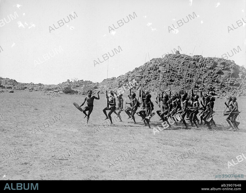 WALTER BALDWIN SPENCER AND FRANCIS J GILLEN. Arrernte welcoming dance, entrance of the strangers, Alice Springs, Central Australia, 9 May 1901. Date/Period: 1901. Image. Glass plate negative. Height: 80 mm (3.14 in); Width: 106 mm (4.17 in).