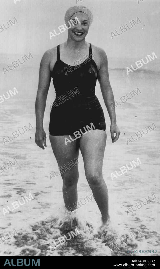 Awaits Start Of Channel Swim -- Florence Chadwick dips her feet into the Pacific to test the temperature as she awaits the start, of her attempt to swim from Catalina Island to the San Pedro headlands tonight. She hopes to negotiate the 21 miles in 15 hours to become the first woman to swim the channel. Only one man has ever done it. July 03, 1952. (Photo by AP Wirephoto).