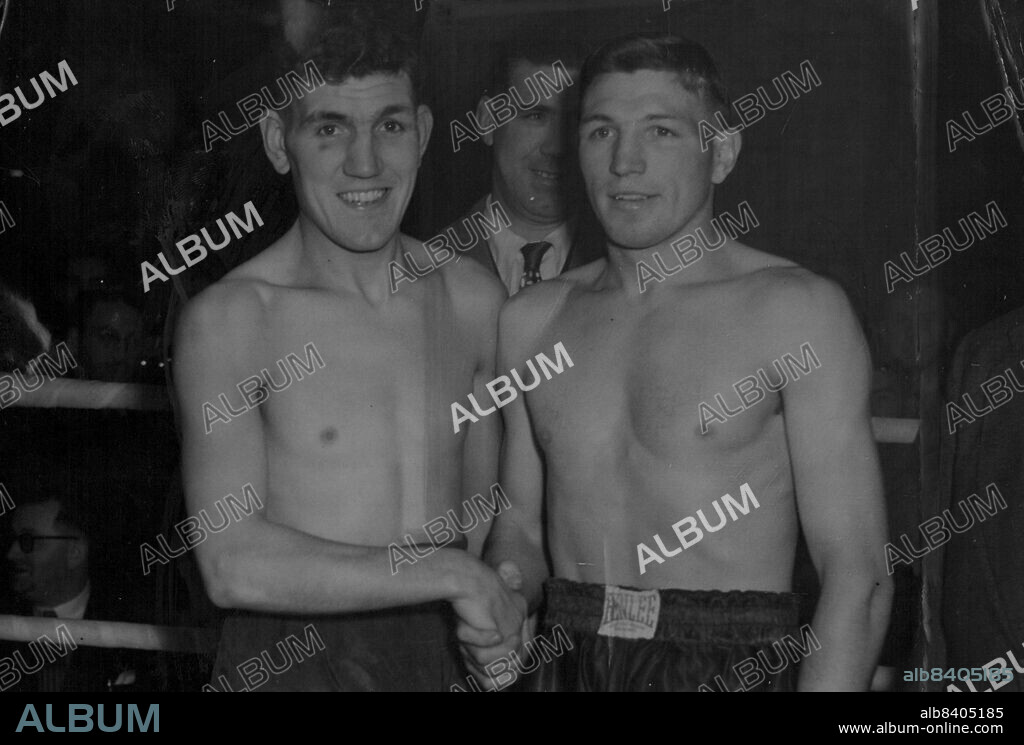 Weigh - In For Title Fight -- Henry Hall (left) and Eddie Thomas shake hands at the wiegh-in to-day (Tuesday).Henry Hall of Sheffield, the British Welterweight champion and his challenger 23-year-old Eddie Thomas from Marthyr, weighed in at Jack Solomon's gymnasium in London for the title-fight at the Harringay Arena North London, to-night (Tuesday). Also weighing in were Randloph Turpin, brother of the British middleweight champion, and the American, Pete Mead, who are fighting over than rounds on the came bill. November 15, 1949. (Photo by Reuterphoto).