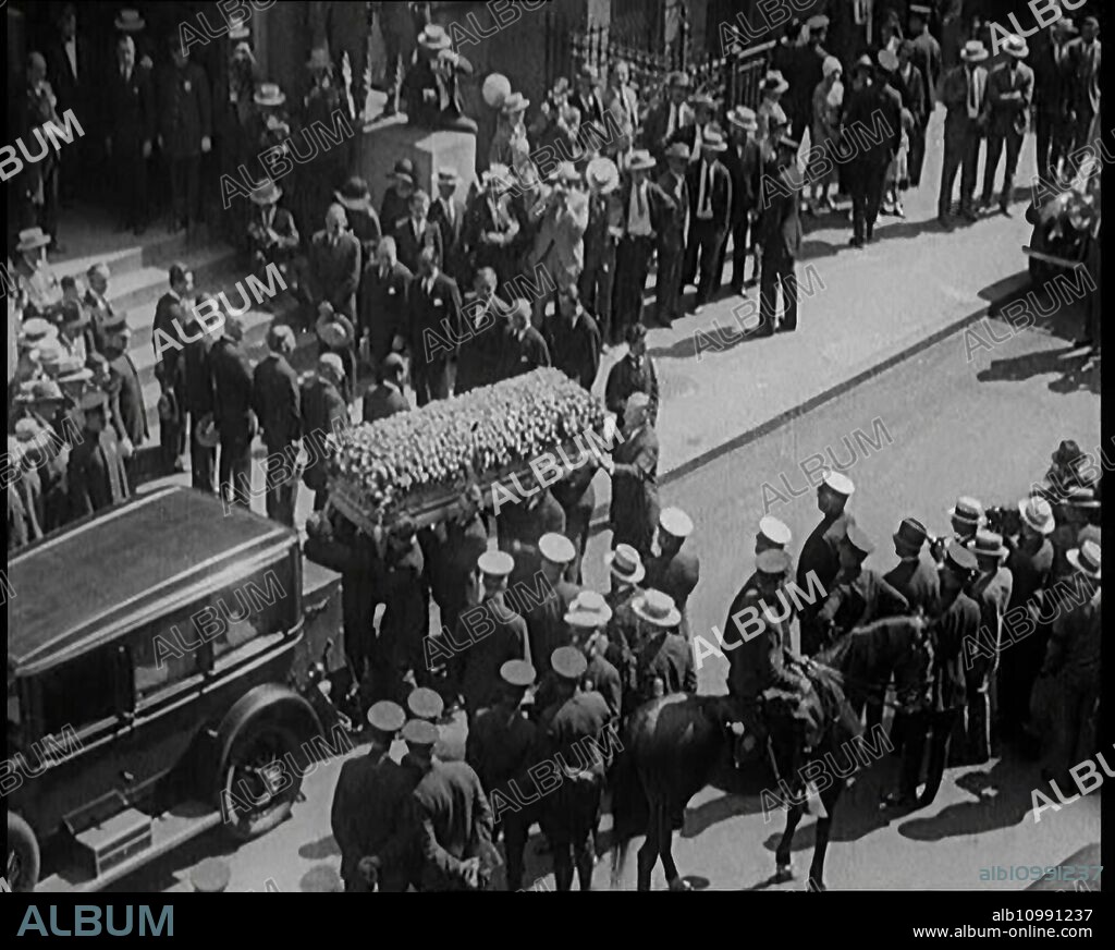 The Coffin of Rudolph Valentino Being Carried Into Malachy's Church Actor's Chapel as a Large Crowd of People Watch, 1926. ''He was the screen idol of millions - of just how many millions we were only to find out...when one day in 1926, unexpectedly, he died...and for untold numbers of the world's women, it was as though their own hearts had stopped...100,000 lined the route [of the funeral cortege]'. From "Time to Remember 1926 - Short Sharp Shower"- Reel 1; a documentary about 1926 - General Strike, international politics, dancing, weather and record breaking feats.