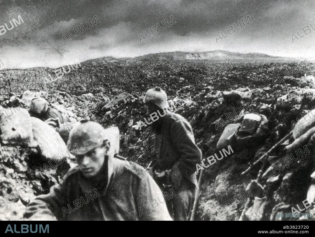 Germans in trench near Verdun, as their artillery barrage begins. The Battle of Verdun was fought from February 21 - December 18, 1916 during WWI on the Western Front between the German and French armies, on hills north of Verdun-sur-Meuse in north-eastern France. The concentration of so much fighting in such a small area devastated the land, resulting in miserable conditions for troops on both sides. Rain combined with the constant tearing up of the ground turned the clay of the area to a wasteland of mud full of human remains. Shell craters became filled with a liquid ooze, becoming so slippery that troops who fell into them or took cover in them could drown. Forests were reduced to tangled piles of wood by constant artillery-fire and eventually obliterated. The effect on soldiers in the battle was devastating, many broke down with shell-shock and some French troops attempted to desert to Spain, those who were caught being shot. It was the longest and one of the most costly battles in human history; other recent estimates increase the number of casualties to 976,000.