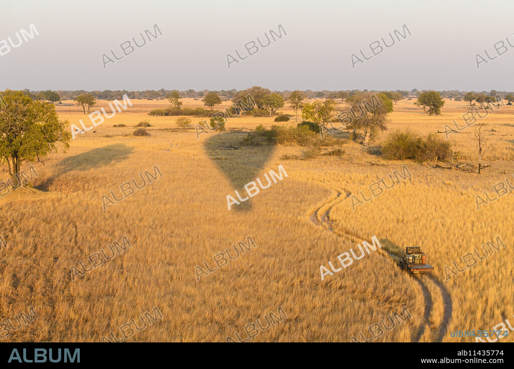 Aerial view of the Okavango Delta from a hot air balloon ride including chase vehicle, Okavango Delta, Botswana, Africa.