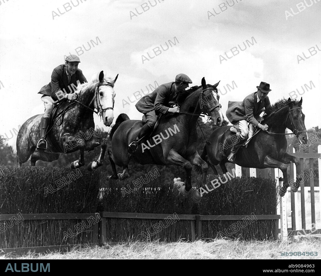 Britain Olympic Horse Trial Team. Three members take a jump during training at Windsor Forest Stud Ascot Michael Bullen on Cottage Romance Captain Norman Arthur on Blue Jeans and Colonel Frank Welson on Dapper 1960.