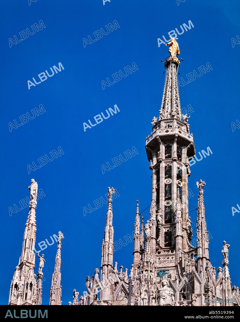 Duomo (the Cathedral): view of some spires and of the statue of the Madonnina, by Giuseppe Perego, made in gilded copper (1774).