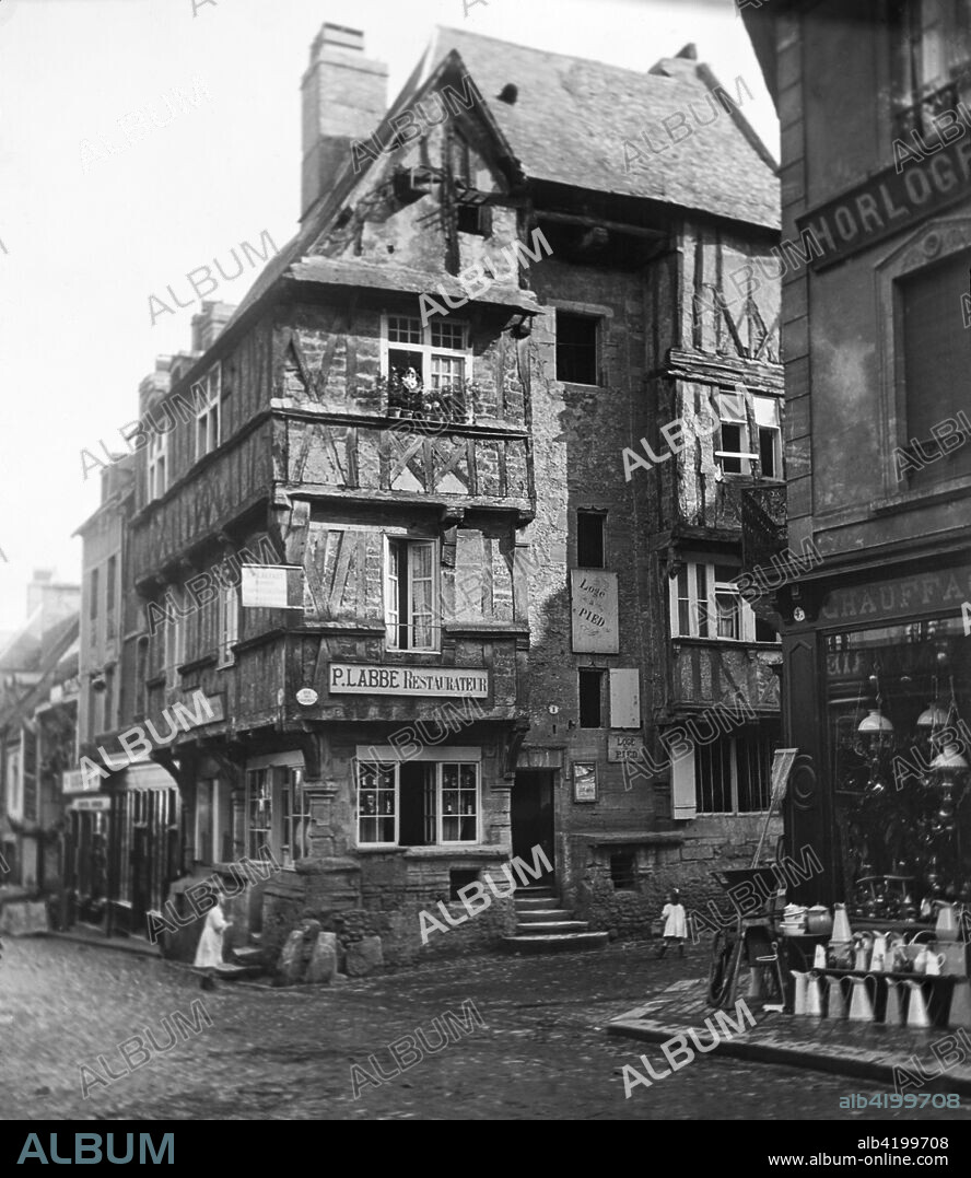 Magic lantern slide circa 1900.Victorian.Social History.. P Labbe, old house in Rue Street St Martin,Bayeux,France. A street scene in france with vases,jugs,shops,children.