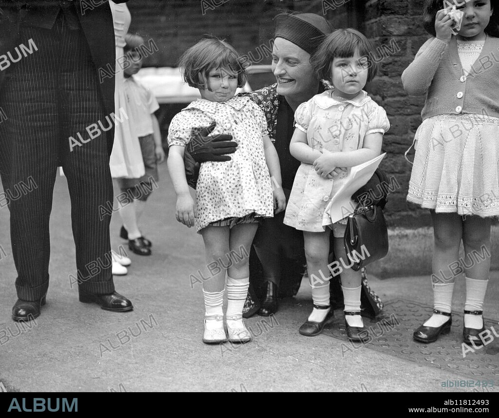 North Lambeth Babies Care Centre Silver Jubilee Fete. Baroness Ravensdale possibly Mary Irene Curzon, 2nd Baroness Ravensdale with some of the youngsters. 20 May 1937.