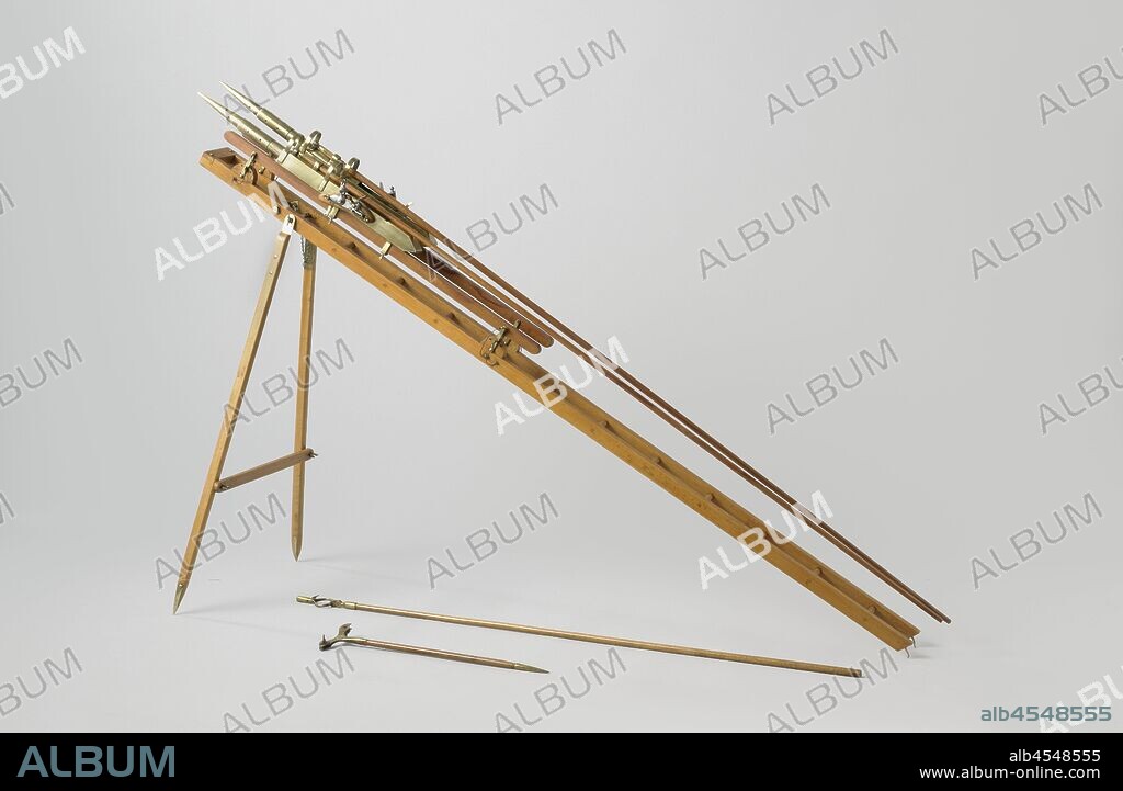 Model of Two Congreve Rockets with Launching Gear, Model of two fire missiles, designed by Congreve on a launcher or chair, for use on land. The rockets themselves consist of a pointed cylinder, the tip of which is the fire bomb and the rear part is the rocket engine, a long stabilizing pole is mounted on the outside of the cylinder. The chair consists of a ladder-shaped frame that together with two legs forms a tripod, A running ring is provided at the front of the frame, which can be wrapped around the front mast of a sloop and guides the movement of the frame during lifting and lowering for aiming and loading. A beam with a metal chamber and flint lock is mounted on each leg of the frame with a set of brackets. The flint locks have tractors with holes for a tractor rope. The head of the rocket is placed under two brackets in the chamber. The spark from the flint lock is blown off by a plate in the room to get to the back of the rocket. This model is equipped with two wick sticks: one for a single wick with a round bracket at the end, the other with a forked end for two wicks for simultaneous firing, and with a point at the lower end., Rijkswerf Rotterdam, 1818, wood (plant material), brass (alloy), iron (metal), leather, rope, frame: h 70 cm × l 123.5 cm legs: w 35.3 cm.