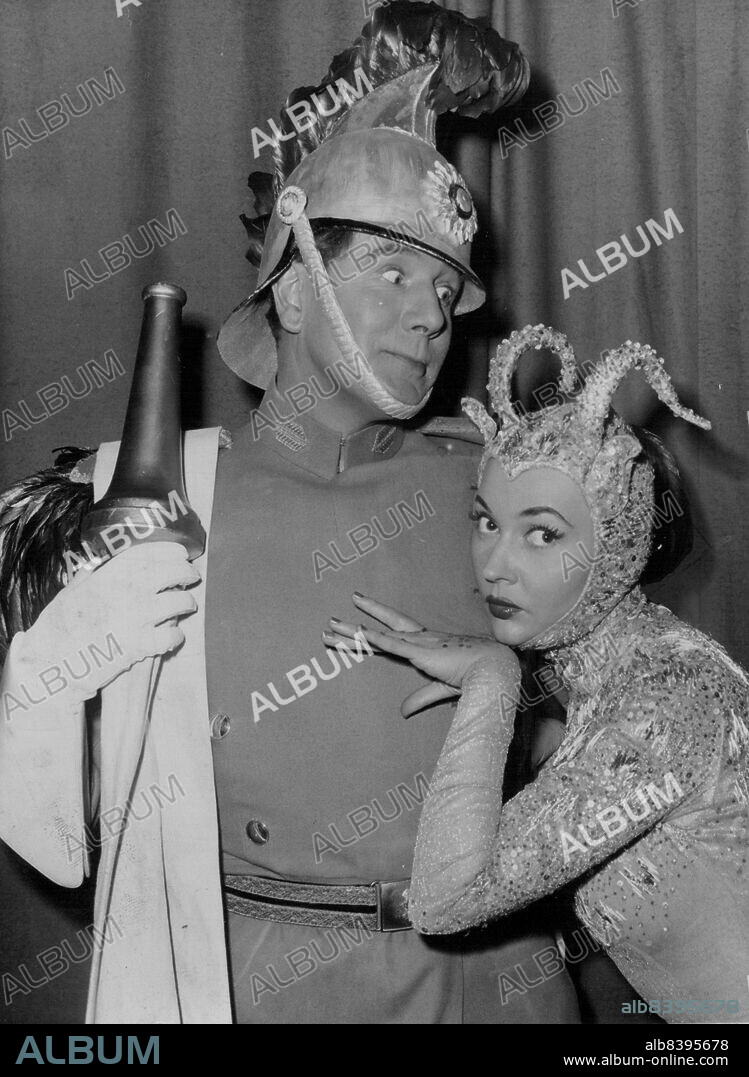 The Fireman And The Lady -- Michael Redgrave as a fireman, and Ludmilla Tcherina, seen today in a scene from the Powell-Pressburger colour and cinema scope film, Oh, Rosalinda, which is now is production at Elstree. Ludmilla has a solo as the Golden Hind, and wears a golden lame gown embroidered with multi-coloured sequins, silver horns and golden hooves.When a fireman rescues a beautiful girl like Ludmilla Tcherina, anything can happen, and producers of the new Cinema-Scope film, Oh, Rosalinda, see to it that it does. Bewildered fireman is Michael Redgrave. February 23, 1955.