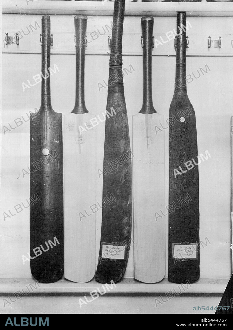 Some Interesting Cricket Bats - In the centre the oldest Bat in existence (1750) and on eit- er side of it 1920 Bats - on the left is Kind Edward's Bat and on The Big ***** another very old bat, about 1760. At the Museum at John Wisden's, the famous Cricket gear makers. Bat in the centre is a real old-timer. It's dated 1750. Bat on the left was King Edward VII's. August 1, 1951.