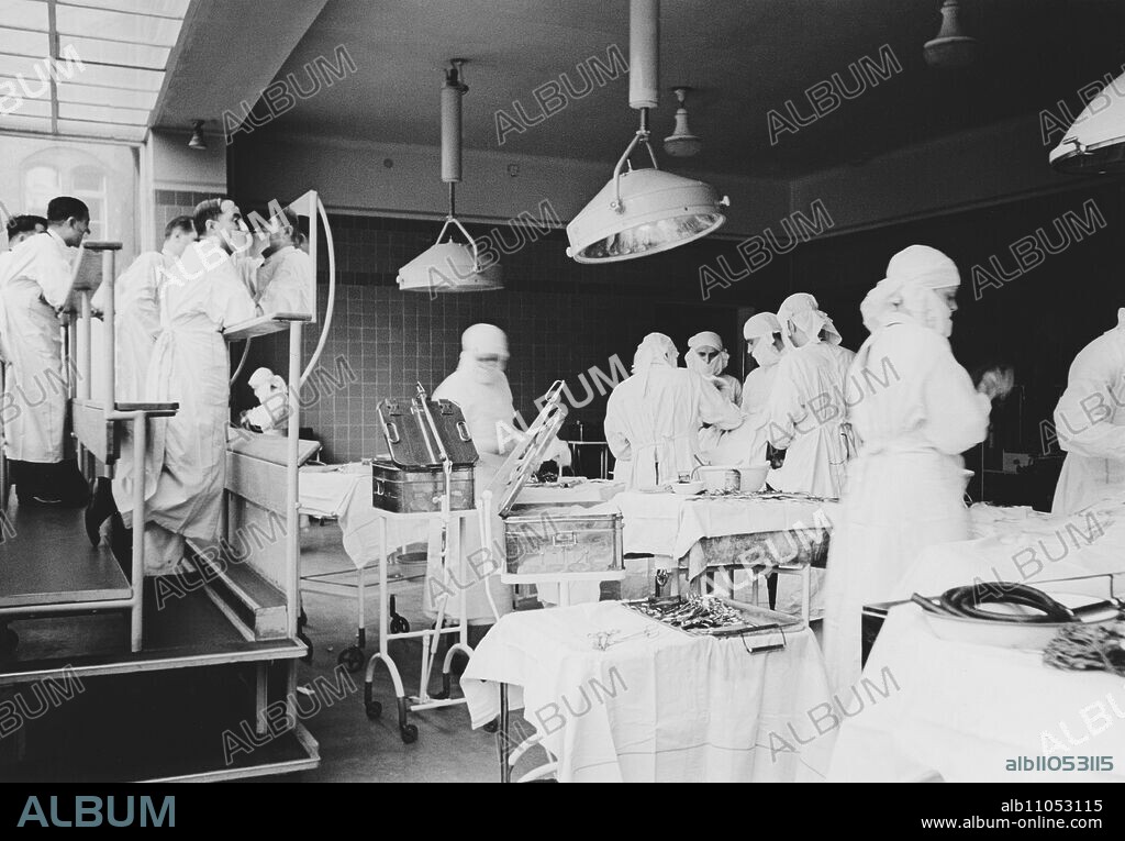 Surgeons during an operation at the old operating theatre of Charite Berlin, Germany ca. 1935.