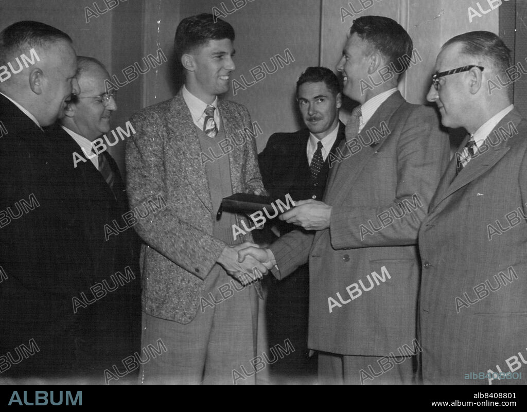 Farewell: Running champion John Treloar (left), who leaves for America tonight, receives a farewell presentation from A.A.A. chairman (Mr. Keith Donald). April 18, 1948.