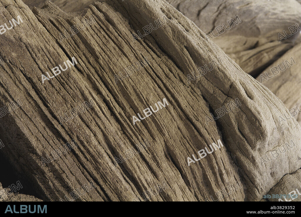 Clay and sandstone compress into very dense, thin layers in Toadstool Geologic Park, Oglala National Grassland, Nebraska. Later geologic events cause the uplifts that tilt the layers.
