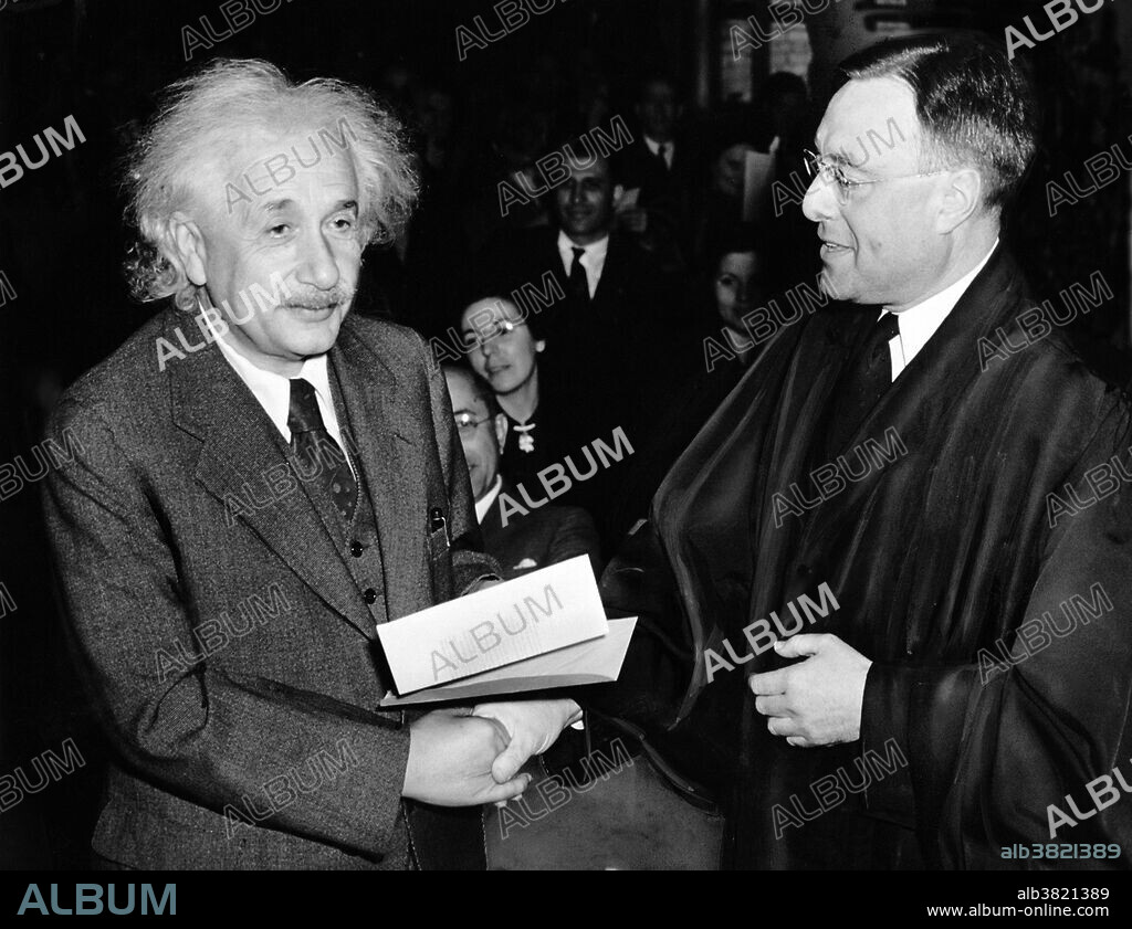 Einstein receiving from Judge Phillip Forman his certificate of American citizenship, 1940. Albert Einstein (March 14, 1879 - April 18, 1955) was a German-born theoretical physicist. He developed the general theory of relativity, one of the two pillars of modern physics. He is best known in popular culture for his mass-energy equivalence formula E = mc2. He received the 1921 Nobel Prize in Physics "for his services to Theoretical Physics, and especially for his discovery of the law of the photoelectric effect". He was visiting the US when Hitler came to power in 1933, and did not go back to Germany. He settled in America becoming a citizen in 1940. He helped alert President Roosevelt that Germany might be developing an atomic weapon, and recommended that the US begin similar research. He was in support of defending the Allied forces, but largely denounced using the discovery of nuclear fission as a weapon. Later, together with Bertrand Russell, Einstein signed the Russell-Einstein Manifesto, which highlighted the danger of nuclear weapons. Einstein was affiliated with the Institute for Advanced Study in Princeton until his death in 1955, at the age of 76. His great intelligence and originality have made the word Einstein synonymous with genius.