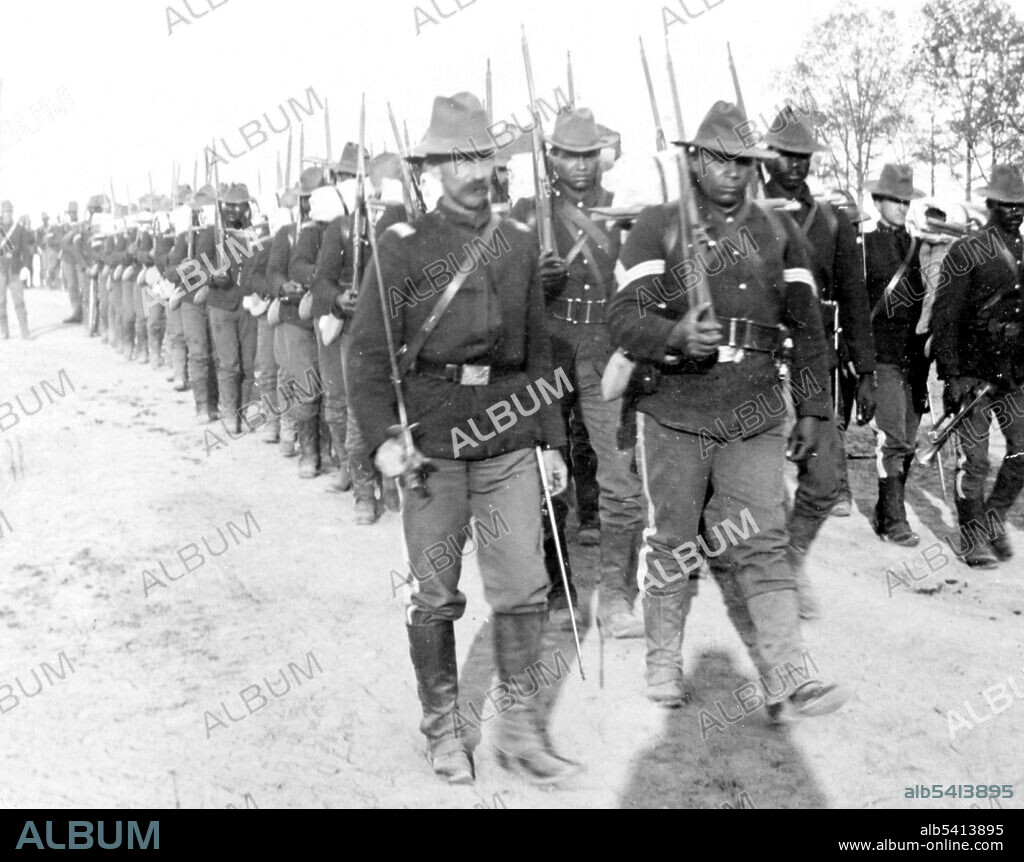 Editorial use only . Tramp, tramp, tramp for Cuba, 24th U.S. Infantry. Buffalo Soldiers originally were members of the US 10th Cavalry Regiment of the US Army. This nickname was given to the Negro Cavalry by the Native American tribes they fought in the Indian Wars. The term became synonymous with all of the African American regiments formed in 1866. The Buffalo Soldiers were established by Congress as the first peacetime all-black regiments in the regular Army. The Spanish-American War was a conflict in 1898 between Spain and the US, the result of US intervention in the Cuban War of Independence. The ten week war was fought in both the Caribbean and the Pacific. US naval power proved decisive, allowing expeditionary forces to disembark in Cuba against a Spanish garrison already brought to its knees by nationwide Cuban insurgent attacks and further wasted by yellow fever. Cropped stereograph, Keystone View Company, 1898.