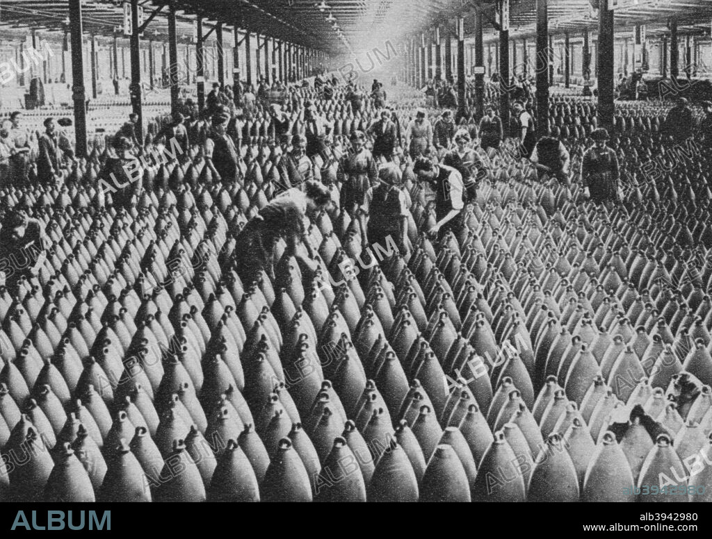 A munitions factory, World War I, 1917 (1938). Munitions workers with shells in a warehouse at National Shell Filling Factory No 6 at Chilwell, Nottinghamshire. From Forty Wonderful Years - A Pictorial Record of Our Times by H. A. Pollock [The Sun Engraving Company, London and Watford, 1938].