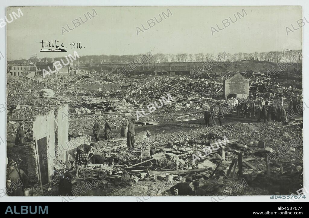 Photograph - Damaged City of Lille, During German Occupation, World War I, 1916, Photograph showing the city of Lille, France, after it was extensively damaged early in World War I. German soldiers are viewing the scene; local people pick through the rubble in the foreground. The photograph was taken in 1916, when Lille was under German occupation. One of 98 black and white photographs contained in a post card album depicting World War I scenes.