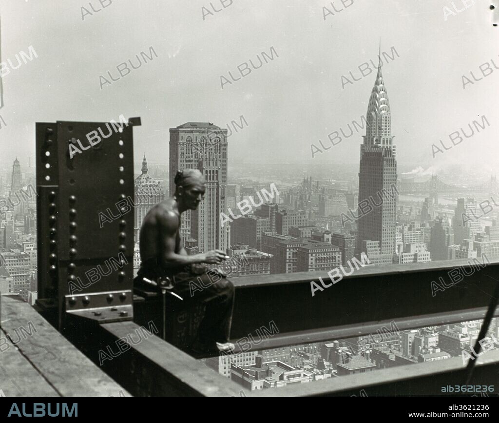 Empire State Building. Artist: Lewis Hine (American, 1874-1940). Dimensions: 10.0 x 12.2 cm (3 15/16 x 4 13/16 in.). Date: 1930s.
Hine took to great heights for this well-known photograph of a construction worker on the Empire State Building taking a break to enjoy a cigarette. Hine's photograph juxtaposes the ordinary (a short break from work) with the extraordinary (the awe-inspiring view of the city). The recently completed Chrysler Building, whose height the Empire State Building eclipsed, appears prominently amid the haze in the middle distance as if already relegated to history.