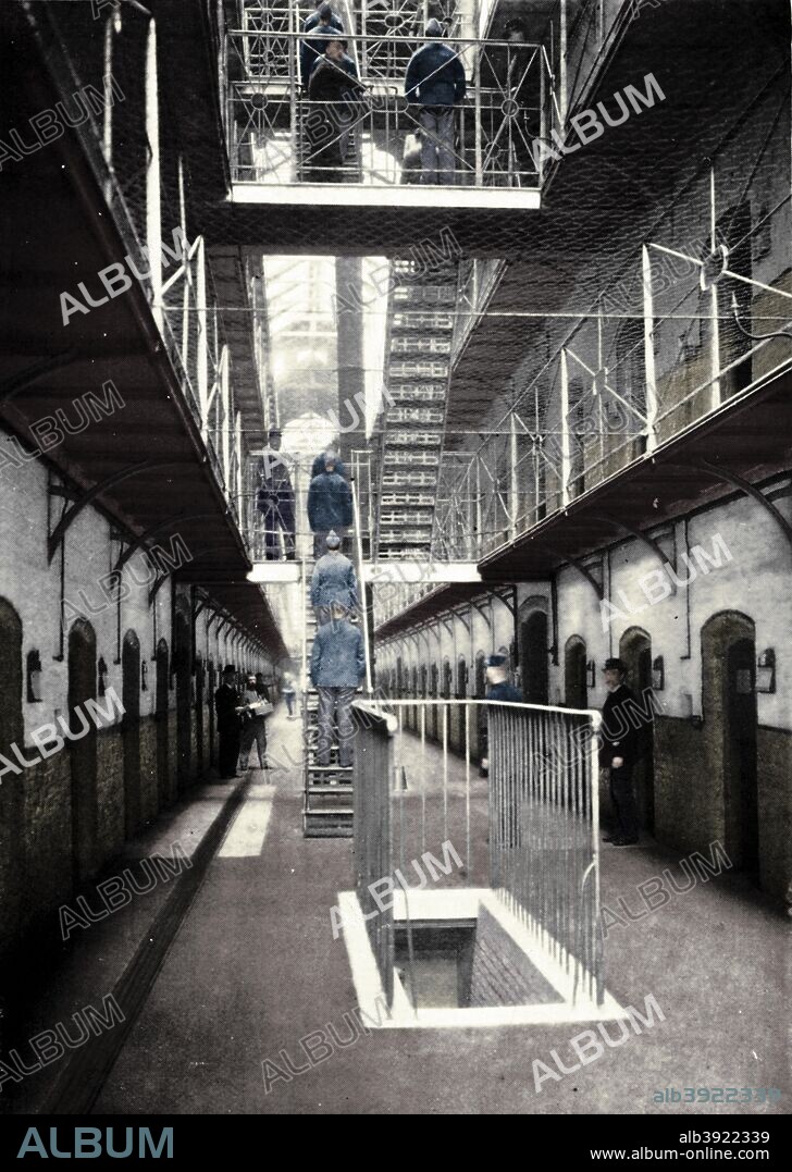 Prisoners going to dinner, Wormwood Scrubs Prison, London, c1903 (1903). HM Prison Wormwood Scrubs is a Category B men's prison opened in 1891, located in the Wormwood Scrubs area of the London Borough of Hammersmith and Fulham. From Living London, Vol. III, by George R. Sims. [Cassell and Company, Limited, London, Paris, New York & Melbourne, 1903]. (Colorised black and white print).