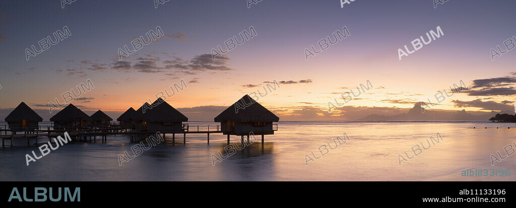 Overwater bungalows at Le Meridien Tahiti Hotel at sunset, Papeete, Tahiti, French Polynesia, South Pacific, Pacific.