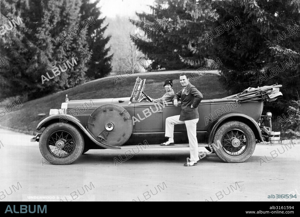 Hot Springs, Virginia: c. 1928 A society couple poses by their car on vacation in Virginia.