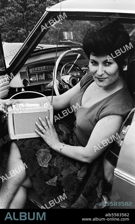 Technology:. Sound Engineering / Radio. Woman with transistor radio in a car. (Publicity photo for transistor radios by Blaupunkt). Photo, undated (c. 1960?).