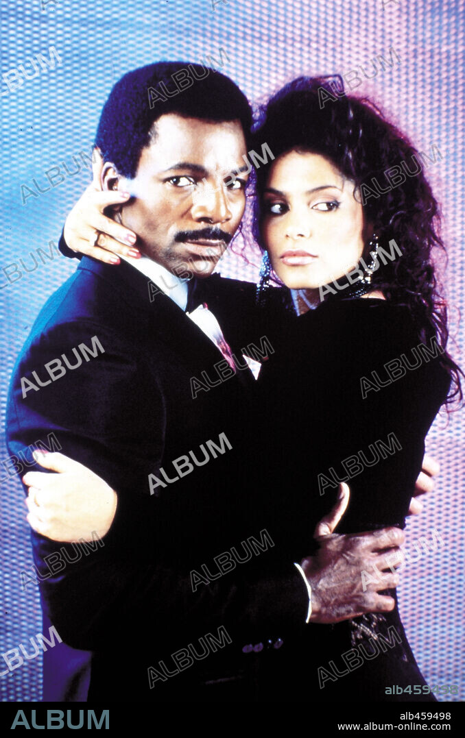 CARL WEATHERS and VANITY in ACTION JACKSON, 1988, directed by CRAIG R. BAXLEY. Copyright LORIMAR.