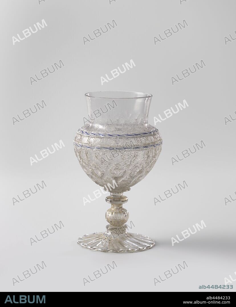 Ice-glass beaker, Flat-ribbed-footed jar with folded edge. The trunk is made up of a ribbed nodus and three discs. Clear glass base and stem. Flattened spherical body of ice glass, blown into a diamond pattern. Slightly bent neck of clear glass. Twice a blue-white thread on the shoulder between two lattimo threads. Remnants of gilt on the foot, the trunk, the underside of the body and the shoulder., anonymous, Nederlanden, c. 1550 - c. 1600, glass, gilding, h 14.9 cm × d 8.7 cm.