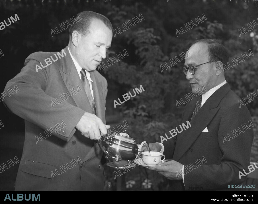 On The Cup, A Hammer And Sickle -- Jacob Malik, the Soviet ambassador, pours tea into a hammer-and-sickle cup for Shunichi Matsumoto, the former Japanese ambassador to London, at the Soviet Embassy in London, August 30. The two men have been meeting at intervals over the past two months in discussions aimed at the restoration of normal relations between their Countries. Their talks have now reached the stage of a draft treaty. August 31, 1955. (Photo by Associated Press Photo).