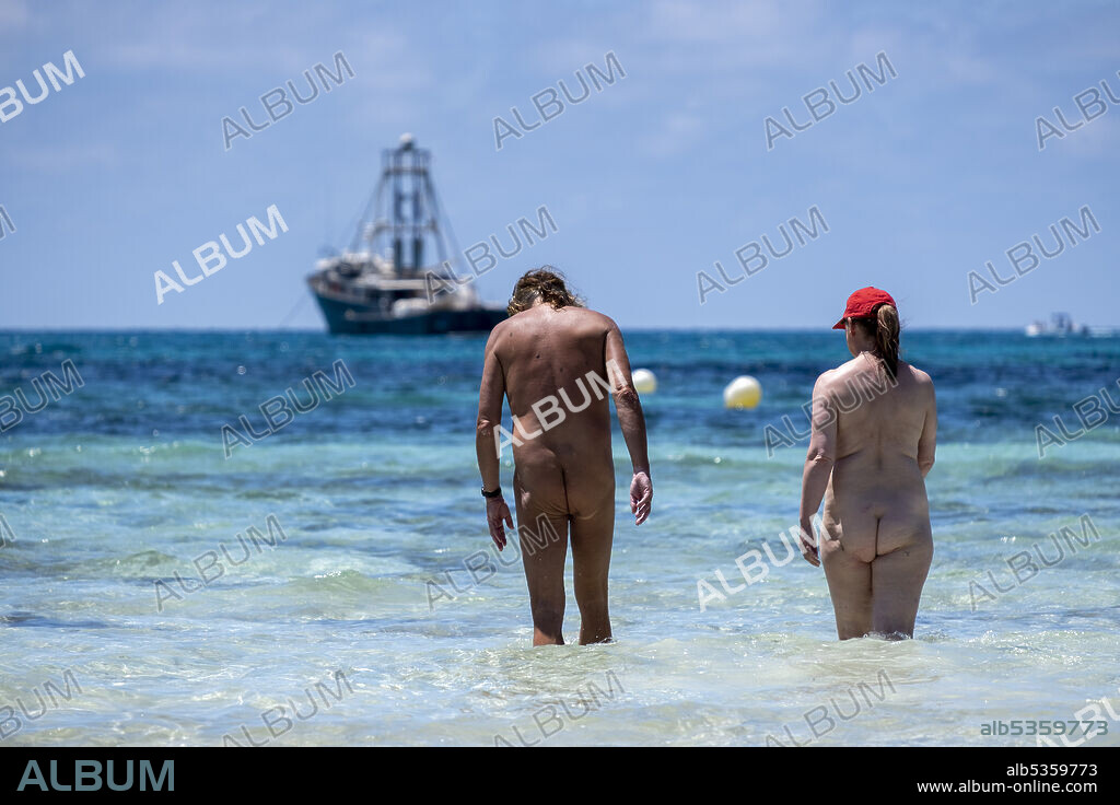 nudist couple bathing, Es Trenc beach, Campos municipality, Mallorca, Balearic Islands, Spain.