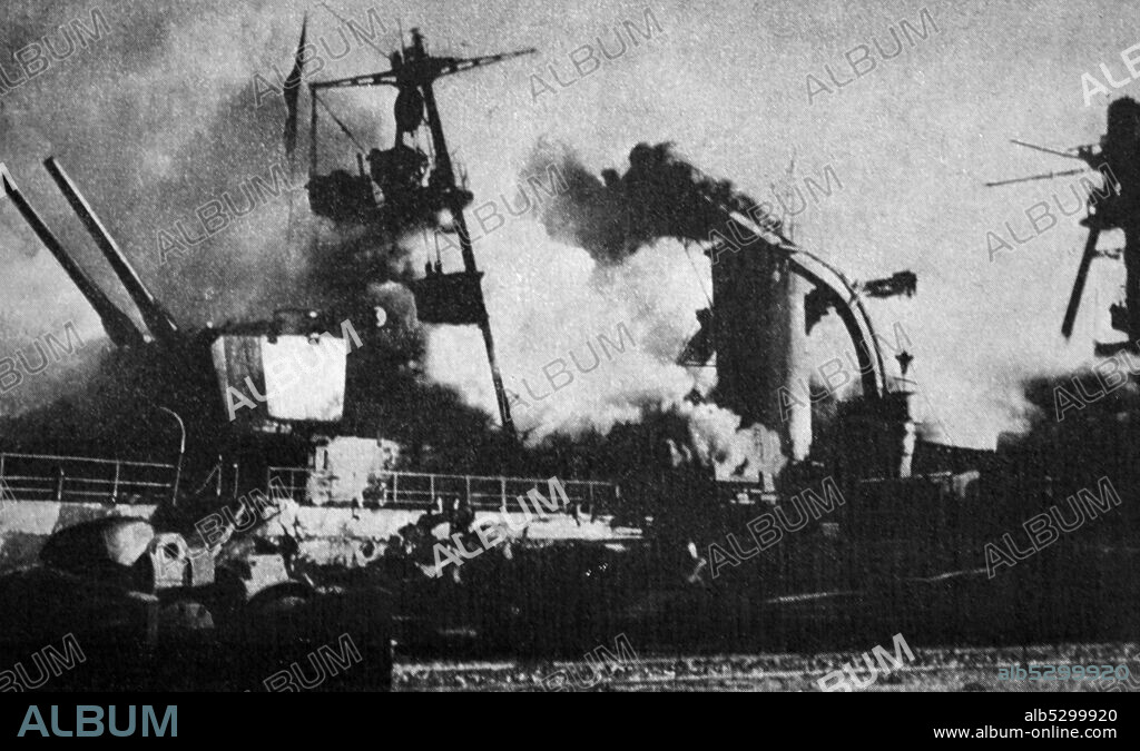 Black and white photograph of World War II (1939-1945); the intentional sinking of the French fleet in Toulon, with a photo of the French ship 'Dupleix' in flames.