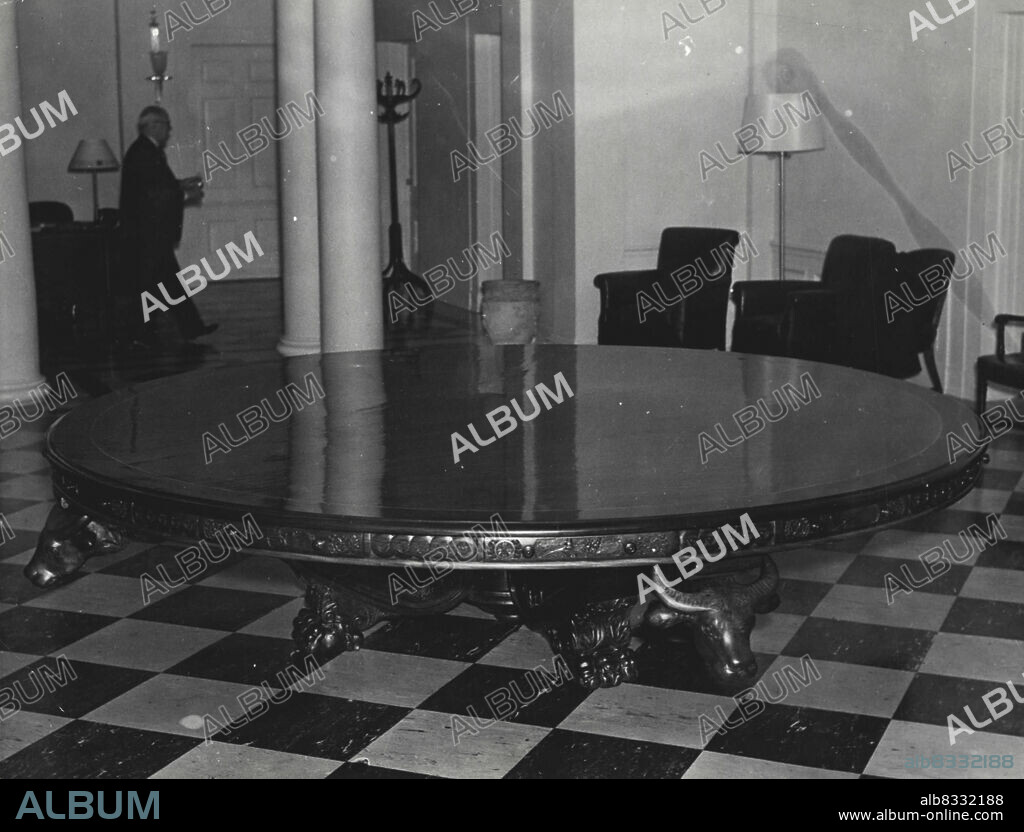 President Gets Gift From Philippines.A Huge Circular Table of Philippine Hardwood, presented to President Roosevelt By Gen. Emilio Aguinaldo, of the Philippine Islands, was set up in the Lobby of the white house executive offices Jan. 10. The center portion of the top is one Piece, Nearly 9 feet 6 inches in Diameter. October 1, 1935. (Photo by Associated Press Photo).