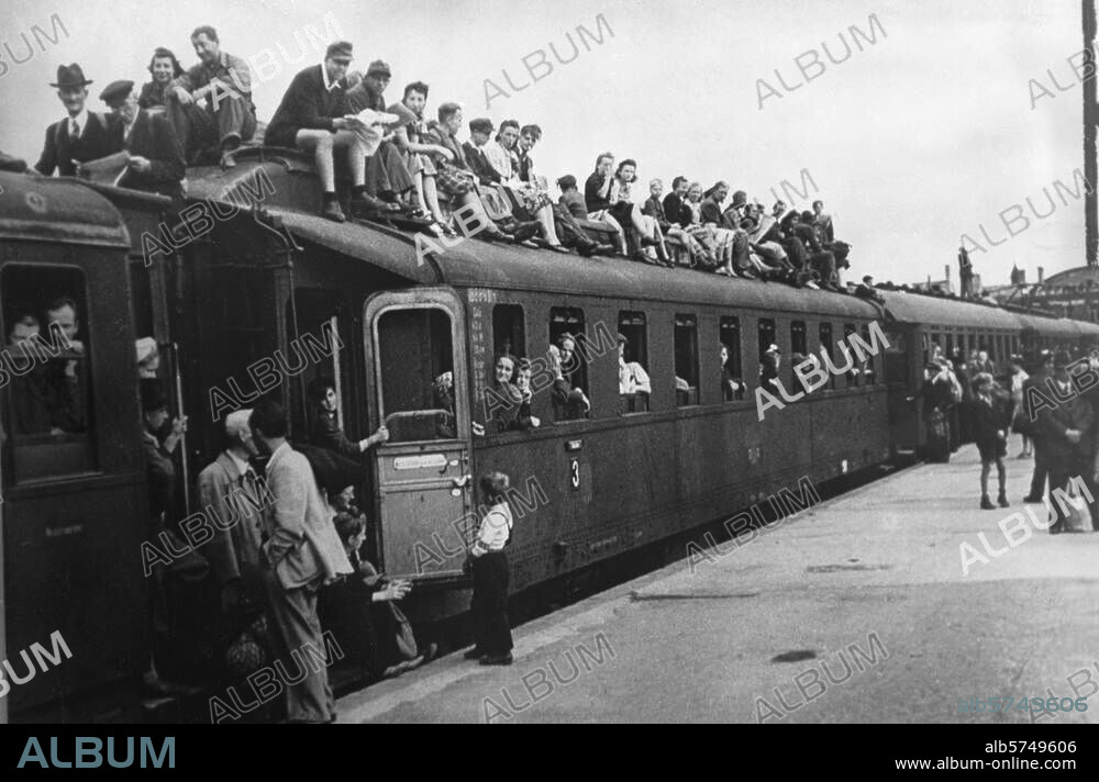 Berlin, Post-war period:. Over-crowded train at a station. Photo, July 1945 (Abraham Pisarek).