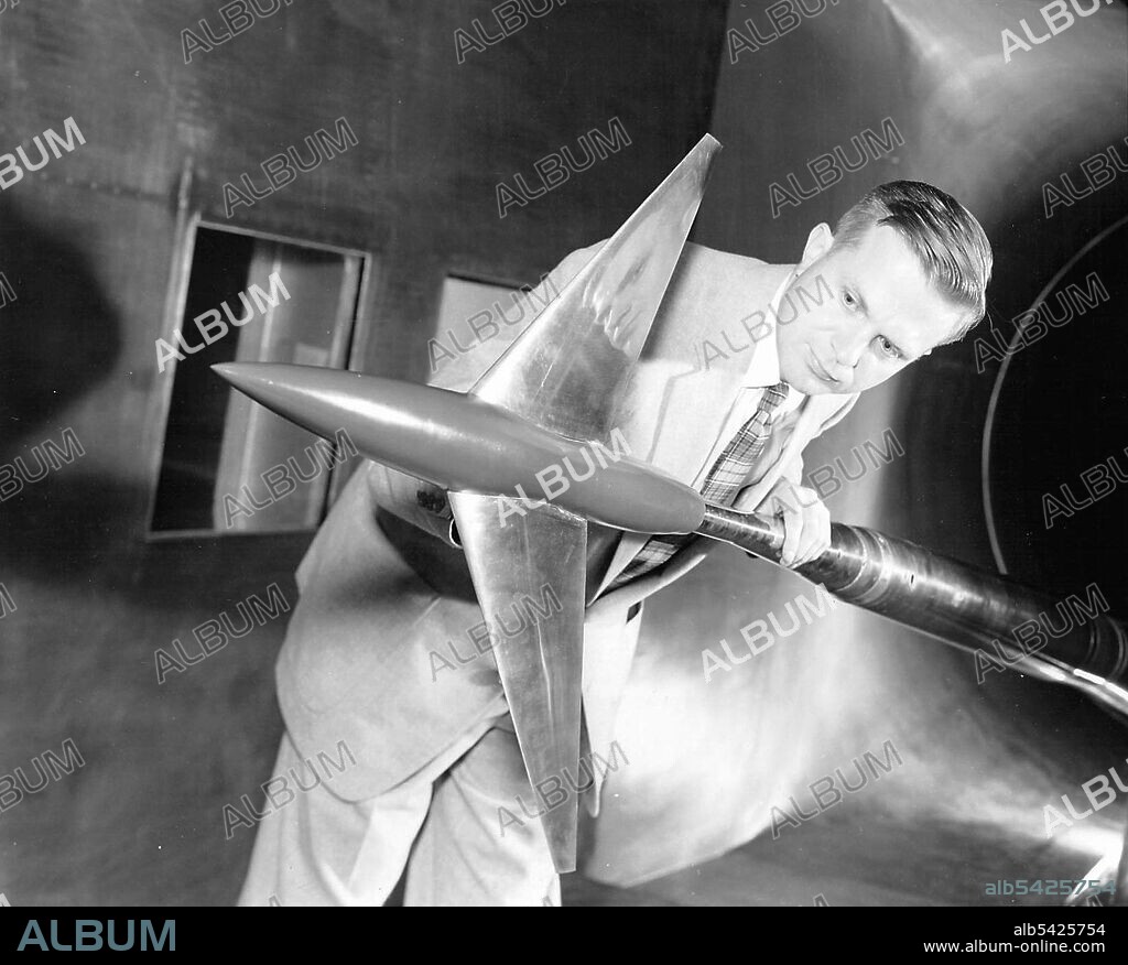 Richard Whitcomb with Area Rule Wind Tunnel Model, USA, April 20, 1955. Aviation pioneer Richard Whitcomb worked at the Langley Research Center in Virginia throughout his exceptionally prolific life. His first major breakthrough was the development of the "area rule," which dramatically reduced drag, particularly at high speeds. He won the Collier Trophy on December 18, 1954, in recognition of this breakthrough. He is shown here in the Langley 8-Ft Transonic Wind Tunnel with an Area Ruled Aircraft test model. Whitcomb later went on to develop the supercritical airfoil and winglets.