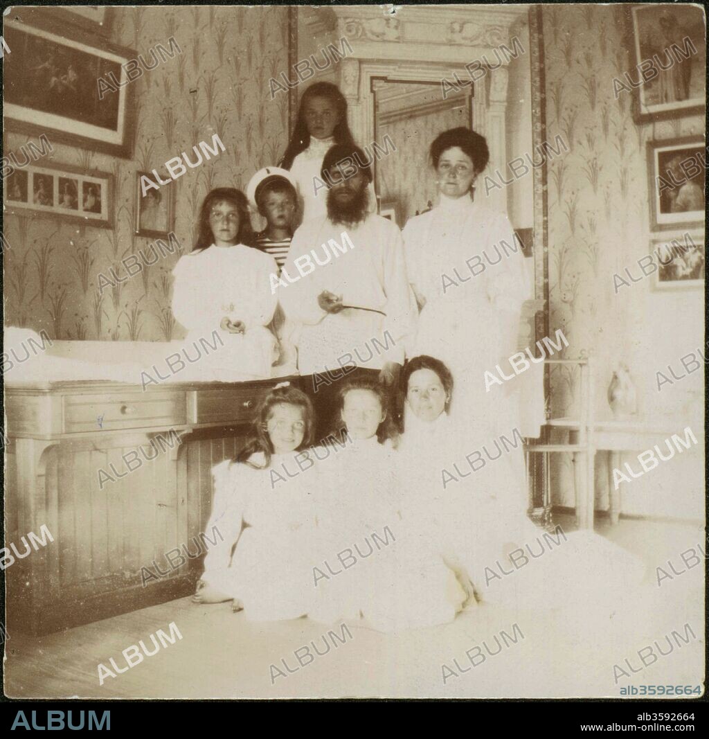 ANONYMOUS. Grigory Rasputin with Empress Alexandra Fyodorovna, her five children and seated right governess Maria Vishnyakova.