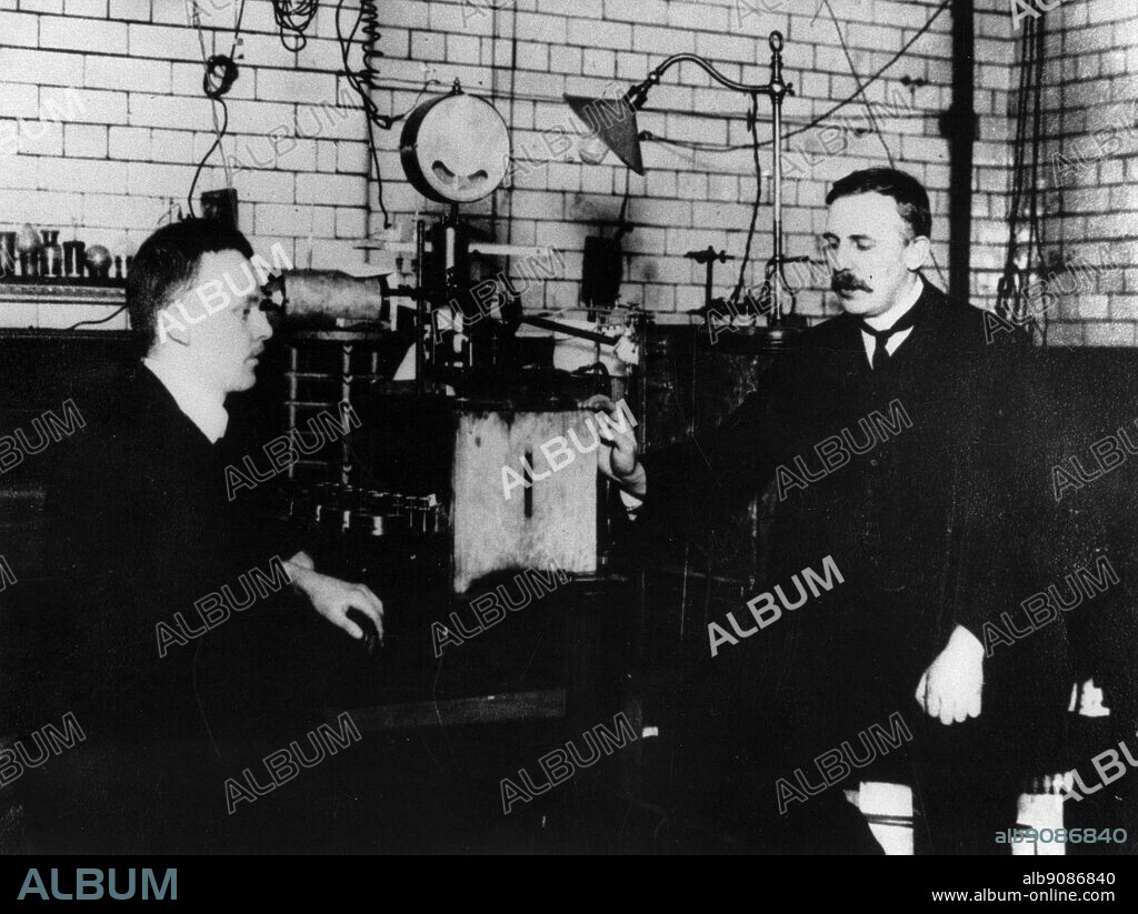 Hans Geiger 1882-1945 and Ernest Rutherford 1871-1937 in the laboratory in Manchester University where they found that alpha particles were the nuclei of helium atoms and that beta rays were particles travelling at very high speeds.