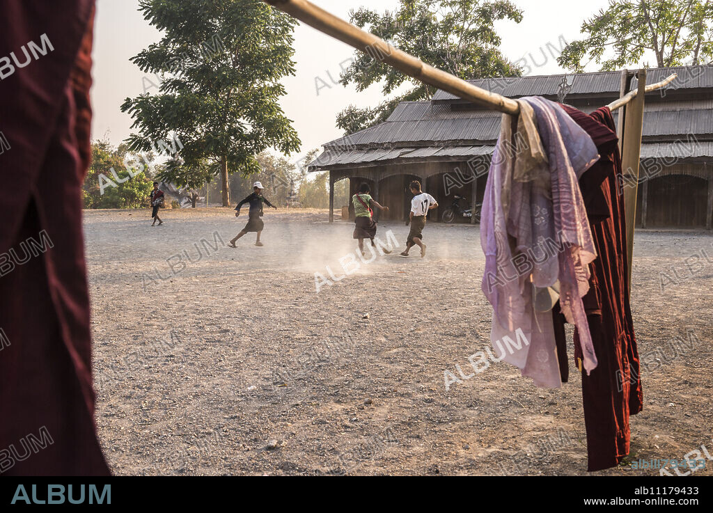 Novice monks playing football at a Buddhist Monastery between Inle Lake and Kalaw, Shan State, Myanmar (Burma), Asia.