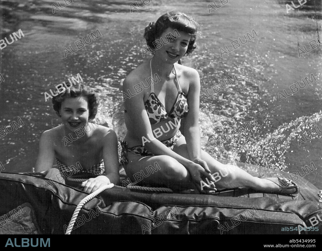 Here's the life for us! Windmill girls Kay Harris, left, and Susan Denny relax on the Thames at Maidenhead. June 04, 1952. (Photo by Daily Mirror).
