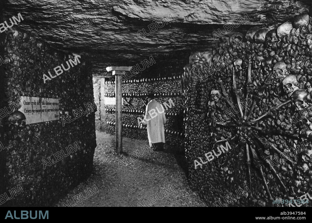 The Catacombs, Paris, 1931. The Catacombs are old quarries which were converted into an Ossuary in 1786. Illustration from the book Paris by Ernest Flammarion, (1931).