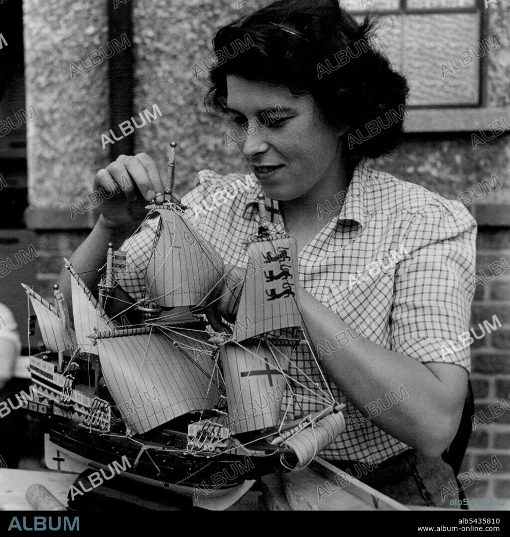Girl's Unusual Hobby -- Patricia Crosby at work on a beautiful little model of Sir Francis Drake's ship "Golden Hind". 21-year-old Patricia Crosby, of Hathaway Road, Grays, Essex. has a hobby unusual in a girl - she builds model galleons and clippers in the evenings at home. Par works at Cannon-street GPO, London, and has twice running won the Post Office hobbies competition for the London area. Offered a pair of silk stockings for her 21st birthday, pat she said she preferred a set of carving.