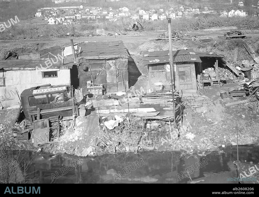 Paterson, New Jersey - Textiles. Bachelor shacks in outskirts of Paterson, on Molly Jan Brook. About 20 men live there now (some of them old silk workers) and stay there all winter. Man in one view worked in silk up to 5 years ago. On relief now, March 1937, Lewis Hine, 1874 - 1940, was an American photographer, who used his camera as a tool for social reform. US,USA.