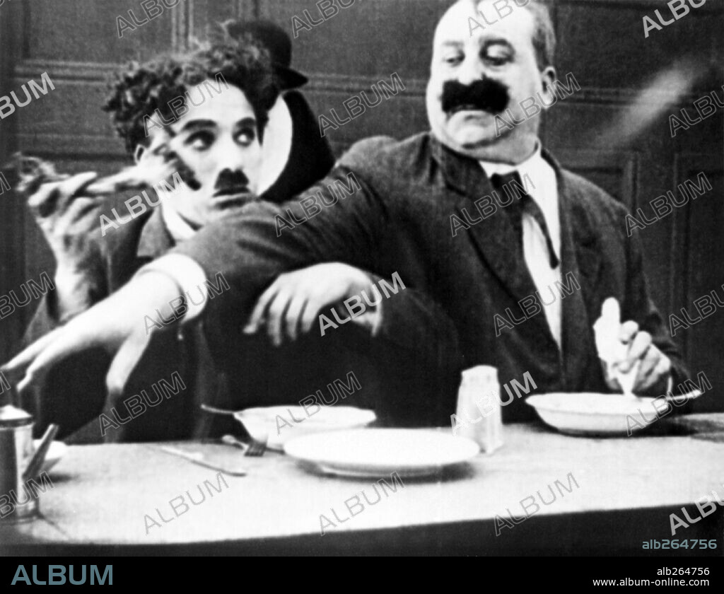 CHARLIE CHAPLIN and MACK SWAIN in HIS TRYSTING PLACE, 1914, directed by CHARLES CHAPLIN. Copyright KEYSTONE.