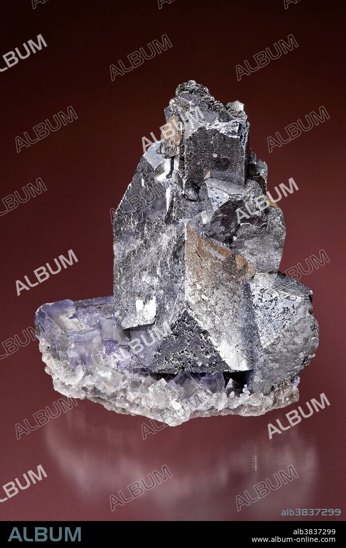 Galena on Fluorite. Galena is the natural mineral form of lead sulfide. It is the most important lead ore mineral. Galena is one of the most abundant and widely distributed sulfide minerals. It has a Mohs Scale hardness of 2.5 - 2.75. Fluorite (also called fluorspar) is a halide mineral composed of calcium fluoride, CaF2. It has a Mohs Scale hardness of 4. Specimen Dimension: approximately 5.5 x 7 x 5 cm. Denton Mine, Southern Illinois, USA.