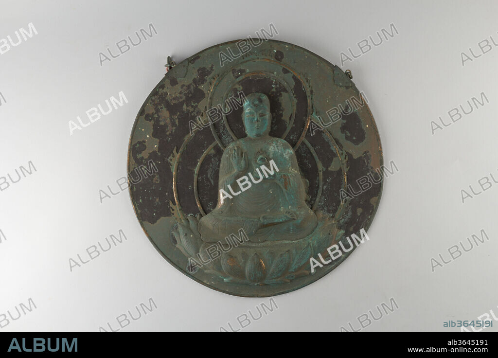 Shinto/Buddhist Votive Plaque with Image of Jizo (Ksitigarbha Bodhisattva) Attached to a Circular Mirror. Culture: Japan. Dimensions: Diam. 14 in. (35.6 cm);
Image on disc: H. 11 7/8 in. (30.2 cm). Date: 12th century.
The kakebotoke is a round metal or wooden disk with a separately made or repoussé (hammered from the rear) image of a Shinto or Buddhist deity imposed upon it. This unusually large example features a gilt repoussé image of the bodhisattva Jizo. The figure, lotus throne, and double halo are all separately modeled by hammering and are attached to the disk with small nails, a technique of the late Heian period.
