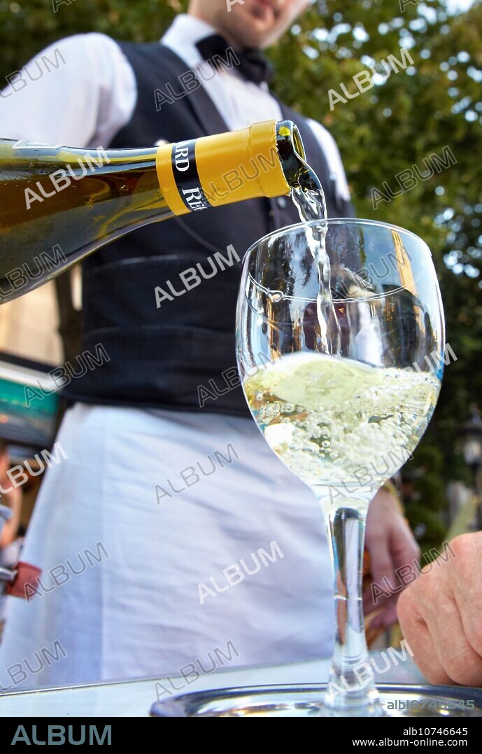 Waiter serving wine chardonnay. Terrace restaurant Des Deux Magots Cafe Bistro. Boulevard Saint Germain. Paris. France. Europe.