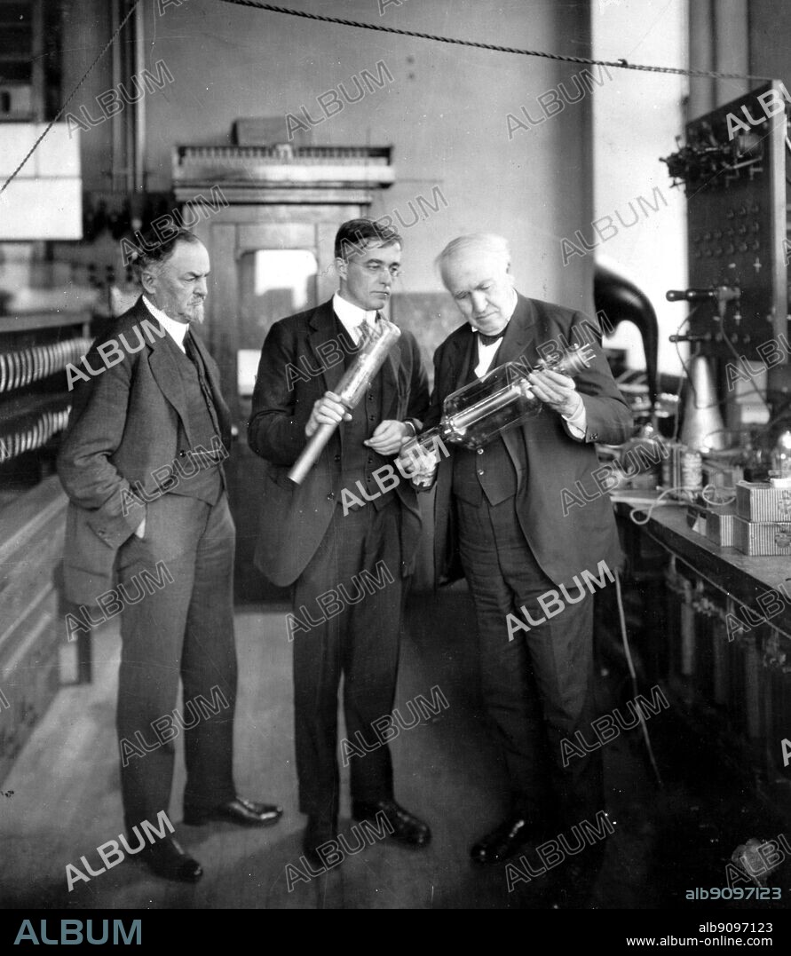 George Morrison on the left, manager of the General Electric Works, and Thomas Alva Edison with Dr. Irving Langmuir, examining vacuum tube in research laboratory 1922.