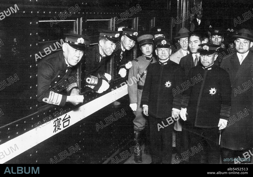Japanese Naval Delegate to the Geneva Disarmament Conference, Vice-Admiral Shushi Nagano taken at the Tokyo Central Station when he depurated for Geneve. Picture Shows from left in train Vice-Admiral Nagano, Rear-Admiral Hasegawa, a delegate, and out of the train, standing in black uniform, form left, Admiral Keisuke Okada, Naval Minister, Admiral Kanji Okada, one of the biggest leaders of the Navy. December 5, 1932.