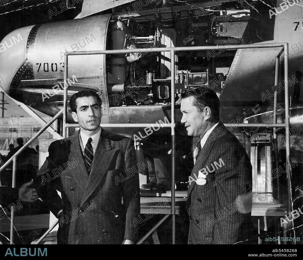 The Shah of Iran (left) who is a qualified pilot, inspecting the lockheed factory during his recent visit to the U.S. as guest of President Truman. February 01, 1950.